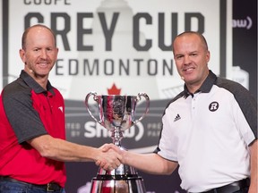 Calgary Stampeders head coach Dave Dickenson, left, and Ottawa Redblacks head coach Rick Campbell, right, arrive for the head coaches news conference in Edmonton, Alta. Wednesday, Nov. 21, 2018.
