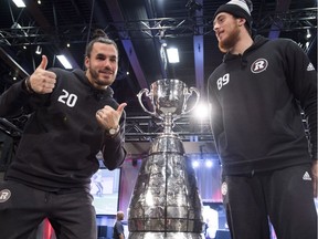 Ottawa Redblacks defensive back Jean-Philippe Bolduc (20) and tight end Marco Dubois (89) pose with the Grey Cup during Grey Cup media day in Edmonton, Alta., on Thursday, Nov. 22, 2018.