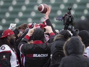 Redblacks players gather together for a huddle during the team's 'walk-through' in Edmonton on Saturday. The Redblacks will face the Calgary Stampeders in the Grey Cup game on Sunday.