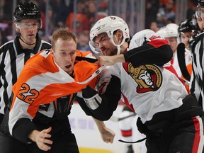 Flyers’ Dale Weise (left) and Senators’ Ben Harpur exchange pleasantries during Tuesday night’s game at the Wells Fargo Center in Philadelphia.
