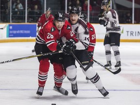 Carleton University Ravens’ Cody Caron (left) and University of Ottawa Gee-Gees’ Quinn O’Brien mix it up during the Colonel By Classic at TD Place Arena. (Errol McGihon/Ottawa Sun)