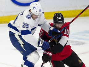 Tampa Bay Lightning defenceman Slater Koekkoek clears Ottawa Senators left wing Tom Pyatt off the puck during first period NHL action in Ottawa, Sunday, Nov. 4, 2018.