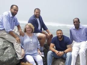 This June 2016 photo provided by Jim Jones Jr. shows, from left, Ross Jones, 21, Erin Fowler-Jones, Robert Jones, 27, and Ryan Jones, 25, and Jim Jones Jr., in Pacifica, Calif. Dozens of Peoples Temple members in Guyana survived the mass suicides and murders of more than 900 because they had slipped out of Jonestown or happened to be away Nov. 18, 1978. Those raised in the temple or who joined as teens lost the only life they knew. Jim Jr. would lose 15 immediate relatives in Jonestown, including his pregnant wife. In the aftermath, he built a new life. He remarried three decades ago, and he and his wife Erin raised three sons with two now in coaching basketball at the high school and college level. (Jim Jones Jr. via AP) ORG XMIT: FX409
