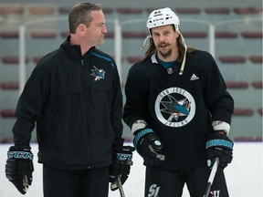 San Jose Shark Erik Karlsson talks things over with assistant coach Rob Zettler during practice at the University of Ottawa athletic facility in advance of his first against his old team, the Ottawa Senators, at Canadian Tire Centre on Saturday.