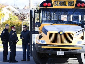 Police work outside École Élémentaire Catholique Lamoureux after children were exposed to an unknown substance on the school bus, in Ottawa on Thursday, November 8, 2018.