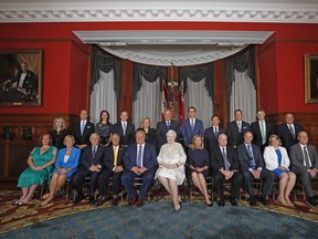 Ontario Premier Doug Ford sits with members of his cabinet prior to being sworn in Friday. (Mark Blinch/The Canadian Press)