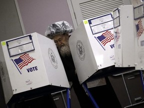 An Orthodox Jewish man fills out his ballot papers at a polling centre in the Brooklyn borough of New York on Tuesday, Nov. 6, 2018.