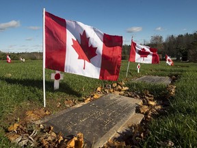 The grave marker of Warrant Officer Arthur W. McIntyre is seen at the Dartmouth Memorial Gardens in Dartmouth, N.S. on Friday, Nov. 9, 2018. Every year the Royal Canadian Legion Centennial Branch places a flag and poppy on the grave of each veteran in the cemetery.