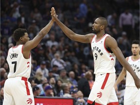 Toronto Raptors' Kyle Lowry, left, and Serge Ibaka give each other a high five during the second half of the Raptors 114-105 win over the Sacramento Kings in a NBA basketball game Wednesday, Nov. 7, 2018, in Sacramento, Calif.