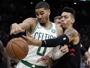 Celtics forward Jayson Tatum (0) fights to control the ball against Raptors guard Danny Green (AP Photo/Elise Amendola)