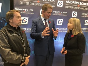 Conservative Leader Andrew Scheer speaks with victims' advocates Joseph and Lozanne Wamback in Brampton, Ont. on Thursday. (Jack Boland/Toronto Sun)