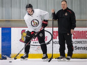 With assistant coach Marty Raymond standing nearby, rookie forward Drake Batherson prepares to join a drill during Senators practice on Tuesday. Wayne Cuddington/Postmedia