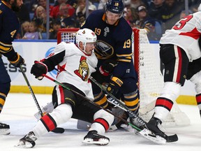 Buffalo Sabres defenseman Jake McCabe and Ottawa Senators forward Mikkel Boedler battle in front of the net during the second period of an NHL hockey game, Saturday, Nov. 3, 2018, in Buffalo, N.Y.