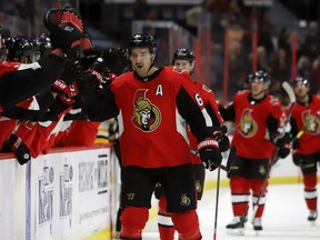 Ottawa Senators winger Mark Stone is congratulated after scoring one of his two goals against the Pittsburgh Penguins at the Canadian Tire Centre on Saturday night.(Fred Chartrand/The Canadian Press)