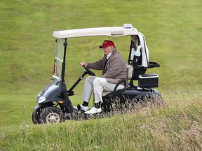 In this July 31, 2015 file photo, Republican presidential candidate Donald Trump drives his golf buggy on the Turnberry golf course in Turnberry, Scotland. (AP Photo)