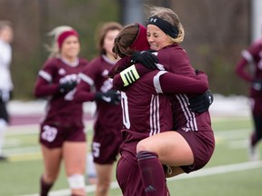 Miranda Smith, right, jumps into the arms of Gee-Gees teammate Mikayla Morton after Morton scored a goal in Saturday's game.