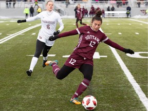 With Lindsay Bosveld (16) of the McMaster Marauders closing in, Thea Abdul Nour of the Ottawa Gee-Gees plays the ball forward during a 2018 U SPORTS Women's Soccer Championship semifinal at uOttawa Gee-Gees Field on Saturday, Nov. 10, 2018. Ottawa won the game 4-1.