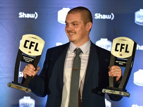 Dual winner, Ottawa Redblacks kicker Lewis Ward holding up his Most Outstanding Rookie and Most Outstanding Special Teams Player awards at the CFL Awards Gala in Edmonton, November 22, 2018. Ed Kaiser/Postmedia