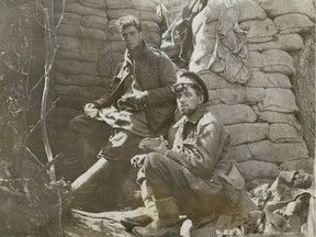 Two soldiers eating in the trenches, June 1916.
