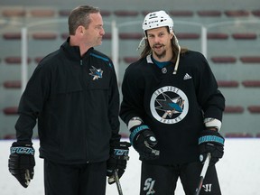 Sharks assistant coach Rob Zettler (left) chats with Erik Karlsson during a practice at the University of Ottawa athletic facility in preparation for Saturday’s game against the Senators. (Wayne Cuddington/ Postmedia Network)