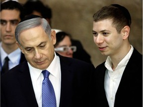 (FILES) This file photo taken on March 18, 2015 shows Israeli Prime Minister Benjamin Netanyahu (L) and his son Yair visiting the Wailing Wall in Jerusalem. The Israeli premier's son has been caught on tape seemingly drunk outside a strip club talking about a key natural gas deal, leading to political fallout on January 9, 2018. On the recording, which was aired by Israel's Channel 2 television late on January 8 and is said to be from 2015, the 26-year-old can be heard speaking with the son of Kobi Maimon, a stakeholder in the company that owns a share in Israel's offshore Tamar gas field.