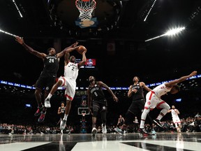Raptors' Kawhi Leonard shoots against Nets' Rondae Hollis-Jefferson during Friday's game in Brooklyn. (GETTY IMAGES)