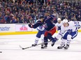 Nick Foligno of the Blue Jackets and Jake Gardiner of the Maple Leafs chase after a loose puck during the second period of a game on Dec. 28. Foligno has announced he will be on indefinite personal leave because his daughter, Milana, is having surgery in Boston.