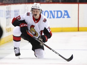 Senators defenceman Thomas Chabot gets back on his skates after taking the hit from the Islanders' Matt Martin in the second period of Friday's game. A shoulder injury from the hit will sideline Chabot for three weeks.