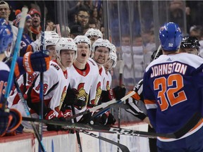 Ryan Dzingel, Brady Tkachuk and Mark Stone of the Ottawa Senators yell at Ross Johnston of the New York Islanders following his fight with Christian Jaros  at the Barclays Center on December 28, 2018 in the Brooklyn borough of New York City. The islanders defeated the Senators 6-3.