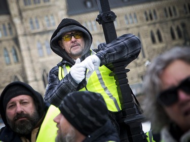 Groups opposed to Canada’s support of the UN Global Compact for Safe, Orderly and Regular Migration held a rally to protest the United Nation Global Compact for Migration while anti-fascism and anti-racism activists counter-protested, Saturday, Dec. 8, 2018 on Parliament Hill. Far-right group members stand and watch the clash of police and anti-fascism and anti-racism activists.