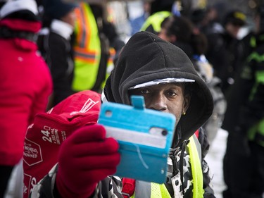 Groups opposed to Canada’s support of the UN Global Compact for Safe, Orderly and Regular Migration held a rally to protest the United Nation Global Compact for Migration while anti-fascism and anti-racism activists counter-protested, Saturday, Dec. 8, 2018 on Parliament Hill. A far-right supporter photographs the media during the protest.
