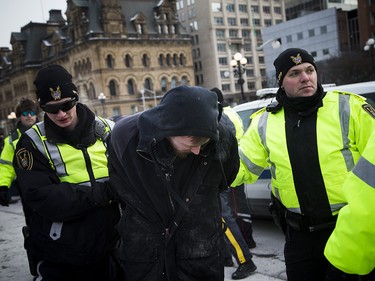 Groups opposed to Canada’s support of the UN Global Compact for Safe, Orderly and Regular Migration held a rally to protest the United Nation Global Compact for Migration while anti-fascism and anti-racism activists counter-protested, Saturday, Dec. 8, 2018 on Parliament Hill. PPS and RCMP detain an anti-fascism and anti-racism activist.