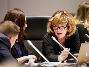 Veteran councillor Jan Harder chats with newbies Laura Dudas and Matthew Luloff at council.