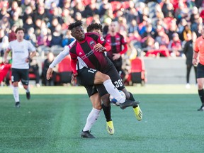 Ottawa Fury FC's Adonijah Reid collides with Nicholas Rittmayer of the Charleston Battery during a United Soccer League match this year. (STEVE KINGSMAN/reestyle Photography for Ottawa Fury FC)