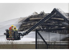 Firefighters at Chester Zoo after a fire broke out in the Monsoon Forest habitat area of the zoo, in Chester, England, Saturday Dec. 15, 2018. The fire forced keepers to evacuate visitors and move animals away from the fire, with winds fanning flames in the inflatable roof of the building.(Peter Byrne/PA via AP) ORG XMIT: LON836