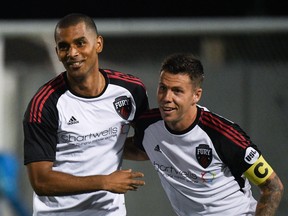 Tony Taylor (left) and Carl Haworth celebrate a Fury FC goal a goal during a USL game in Toronto in September. Ottawa is pushing to remain in the USL. (Martin Bazyl/Toronto FC II)