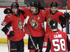 Ottawa Senators right wing Mark Stone (61) celebrates his goal against the Washington Capitals with centre Colin White (36), defenceman Dylan DeMelo (2) and defenceman Maxime Lajoie (58) during third period NHL hockey action in Ottawa, Saturday December 29, 2018.