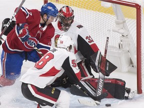 Montreal Canadiens defenceman Brett Kulak (17) battles for control of the puck with Ottawa Senators goaltender Mike McKenna and Ottawa Senators defenceman Maxime Lajoie (58) during the second period on Saturday, Dec. 15, 2018.