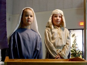 Sophie Glockler and Liam Birtch, students at St. Francis Xavier Catholic School in Brockville, play Mary and Joseph as the school carries on its annual Posada tradition on Friday. Called Las Posadas in the Hispanic world, the tradition re-enacts Mary and Joseph's search for lodgings in Bethlehem before the Nativity.