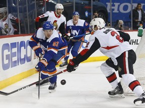 Ottawa Senators defenseman Dylan DeMelo defends against New York Islanders center Casey Cizikas during a game on Dec. 28, 2018, in New York.