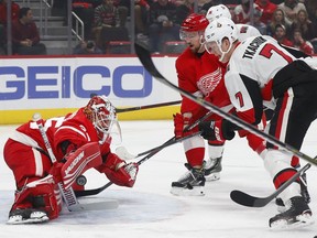 Detroit Red Wings goaltender Jimmy Howard (35) stops the Ottawa Senators' Brady Tkachuk (7) in the first period on Friday, Dec. 14, 2018 in Detroit.