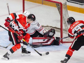 The Ottawa 67's Mitch Hoelscher and Austen Keating press in close, but can't get the puck past Owen Sound Attack goalie Andrew MacLean on Saturday.