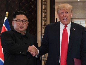 In this file photo taken on June 12, 2018 U.S. President Donald Trump (R) and North Korea's Leader Kim Jong Un shake hands following a signing ceremony during their historic U.S.-North Korea summit, at the Capella Hotel on Sentosa island in Singapore.