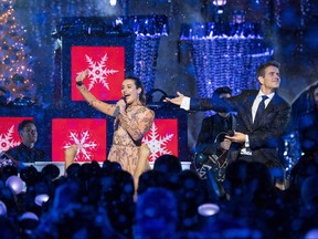 In this handout photo provided by Disney Parks, Lea Michele and Joey McIntyre of NKOTB perform "Baby, It's Cold Outside" during a taping of "The Wonderful World of Disney: Magical Holiday Celebration" at Sleeping Beauty's Castle at Walt Disneyland on Nov. 14, 2017 in Anaheim, Calif. (Matt Petit/Disney Parks via Getty Images)