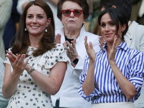 Kate, Duchess of Cambridge and Meghan, Duchess of Sussex, right, applaud during the women's singles final match between Serena Williams of the US and Angelique Kerber of Germany at the Wimbledon Tennis Championships, in London, Saturday July 14, 2018. (Andrew Couldridge, Pool via AP)