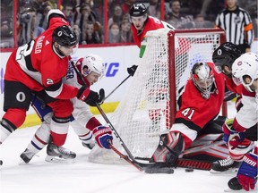Ottawa Senators goaltender Craig Anderson blocks the puck as Ottawa Senators defenceman Dylan DeMelo and Montreal Canadiens right wing Brendan Gallagher fight for it Thursday, Dec. 6, 2018.
