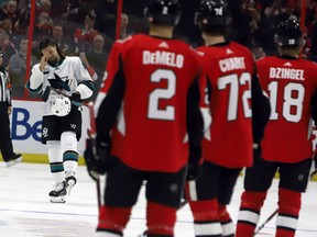 Ottawa Senators players look on as San Jose Sharks' Erik Karlsson is welcomed onto the ice by fans during first period NHL hockey action in Ottawa on Saturday, Dec. 1, 2018. THE CANADIAN PRESS/Fred Chartrand