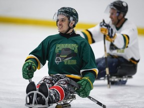 Humboldt Broncos bus crash survivor Ryan Straschnitzki, left, is seen here in a file photo from a fund raising sledge hockey game in Calgary in September.