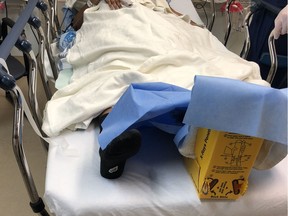 The left foot of Laila Giama is under protective wrapping as she lies in a room at the Civic campus of The Ottawa Hospital on Sunday. Giama, 26, was struck by an OC Transpo bus while crossing an intersection late Saturday.