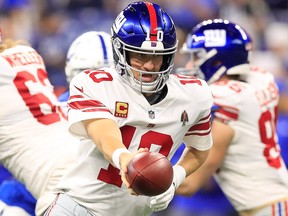 Eli Manning of the New York Giants hands off the ball in the game against the Indianapolis Colts in the second quarter at Lucas Oil Stadium on Dec. 23, 2018 in Indianapolis, Ind.